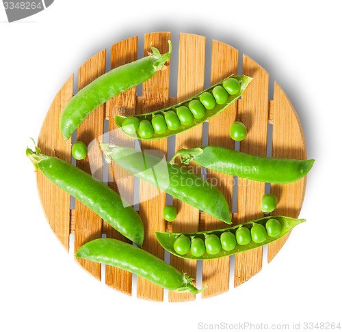 Image of Pods of peas on bamboo board top view