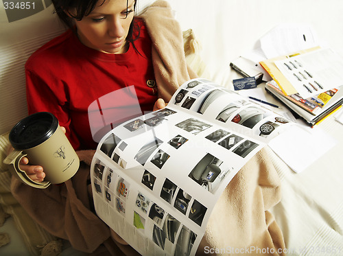 Image of a young woman is reading a new car booklet