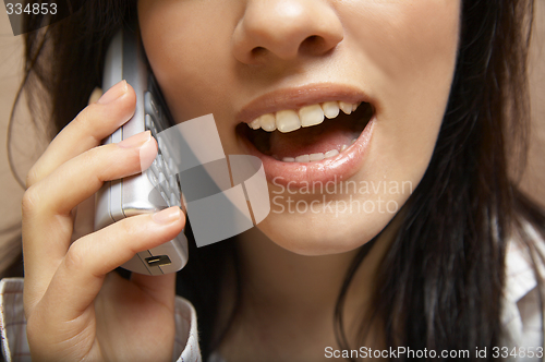 Image of young woman is speaking on cell phone