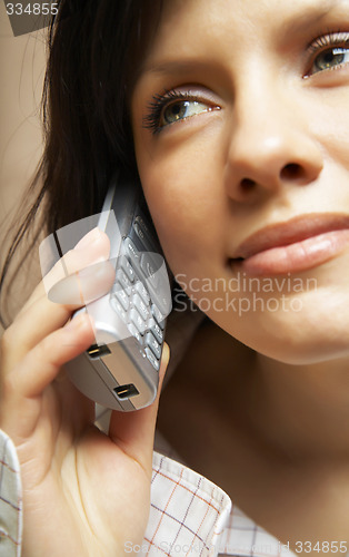 Image of Smiling attractive woman with a phone