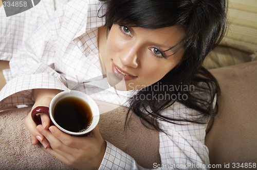 Image of young woman is having her morning tea