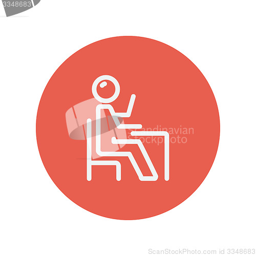 Image of Student sitting on a chair in front of his table thin line icon 