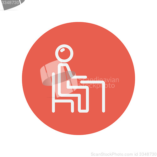 Image of Student sitting on a chair in front of his table thin line icon