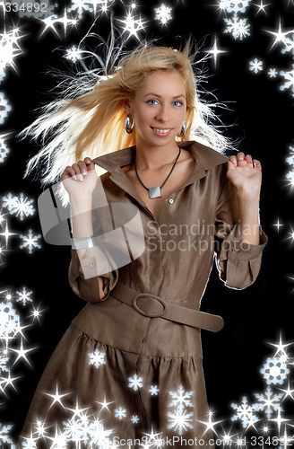 Image of dancing blond in brown dress with snowflakes