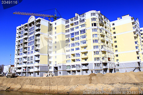 Image of construction of modern house with hoisting crane