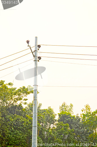 Image of High voltage post tower and power line on sunset sky background for any use.