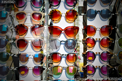 Image of in london glass and sunglasses in the light and reflex