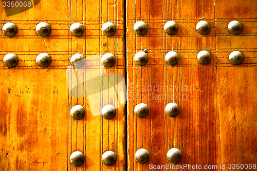 Image of metal  paint in the     red wood door and rusty  yellow  