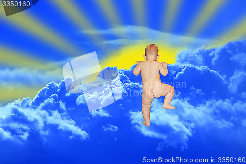 Image of baby climbs to the clouds on the blue heaven