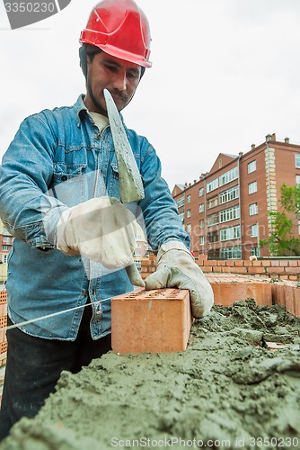 Image of Bricklayer on house construction