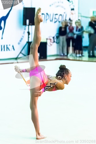 Image of Young attractive girl shows exercise with maces