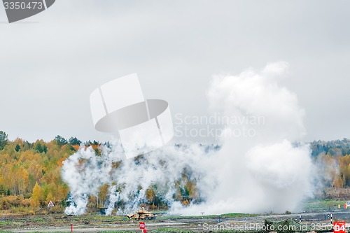 Image of Russian tank T-90 hides in smoke screen from enemy