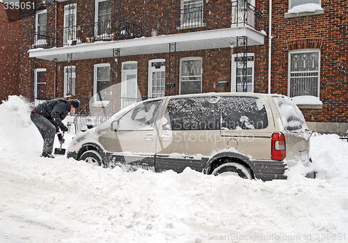 Image of Man shovelling after a snow storm