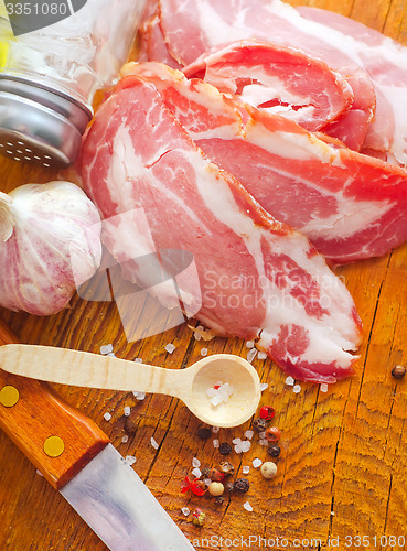 Image of Bacon with aroma spice on the wooden board