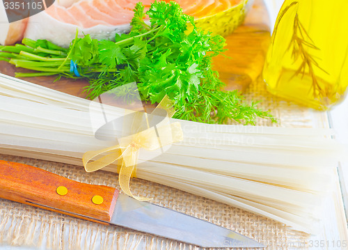 Image of raw rice noodles and raw salmon