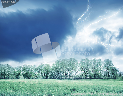 Image of Green field and storm