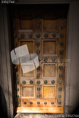 Image of in london antique brown door  rusty  brass nail and light