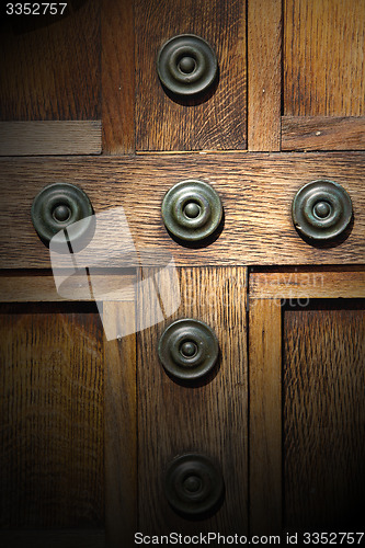 Image of in london antique brown door  rusty  brass nail and light