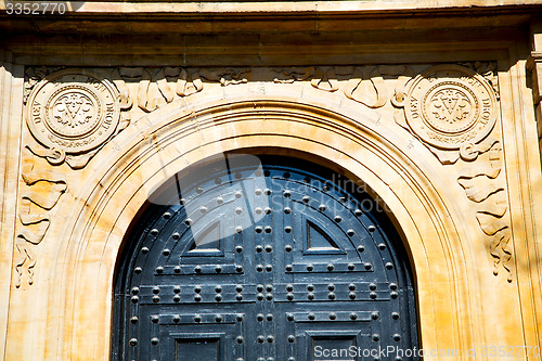 Image of handle in london   door  rusty  brass nail and  