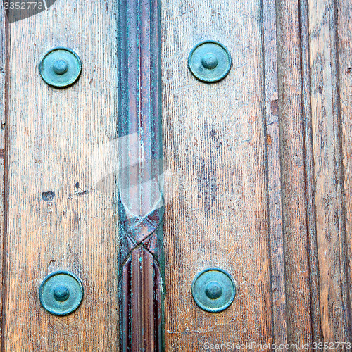 Image of in london antique brown door  rusty  brass nail and light