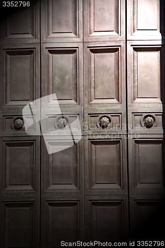 Image of in london antique brown door  rusty  brass nail and light