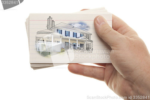 Image of Male Hand Holding Stack of Flash Cards with House Drawing