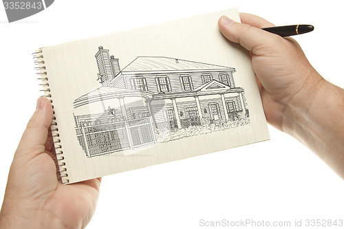 Image of Hands Holding Pen and Pad of Paper with House Drawing