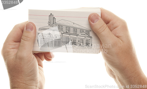 Image of Male Hands Holding Stack of Flash Cards with House Drawing