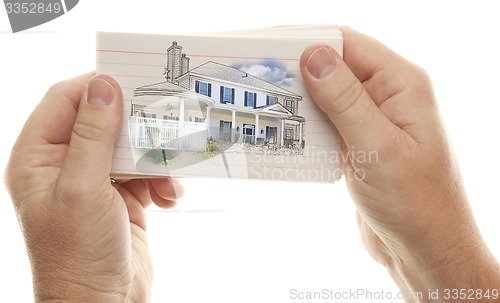 Image of Male Hands Holding Stack of Flash Cards with House Drawing