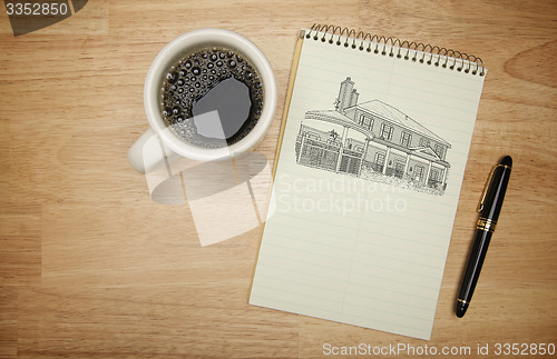 Image of Pad of Paper with House Drawing, Pen and Coffee