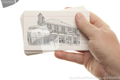 Image of Male Hand Holding Stack of Flash Cards with House Drawing