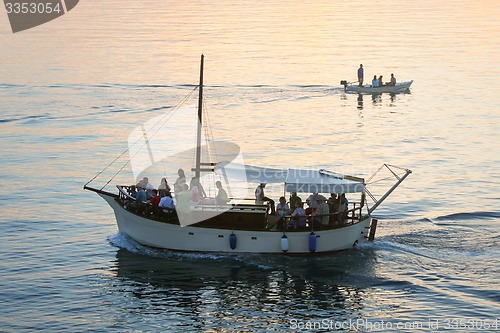Image of Boats sailing at sunset