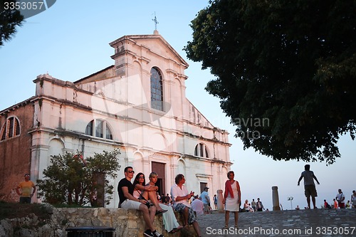 Image of Tourists sightseeing Saint Eufemia church