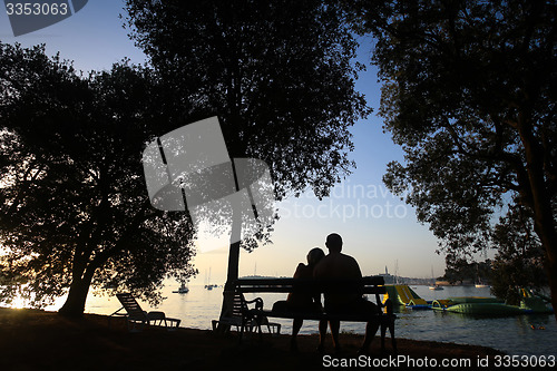 Image of Couple sitting on bench 