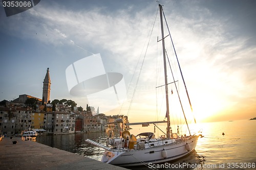 Image of Anchored sailboat at sunset