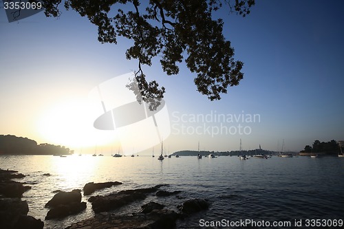Image of Sailboats at sunset anchored in Adriatic sea