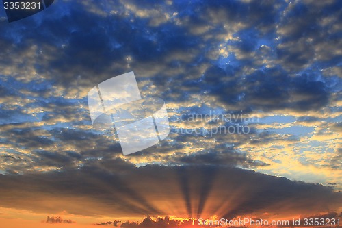 Image of beautiful summer sunset with dark sky and sun