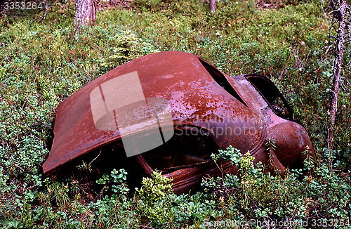 Image of Old rusty car in disintegration.