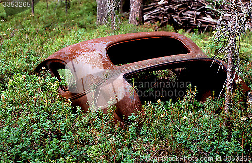 Image of Old rusty car in disintegration.