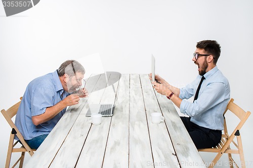 Image of The two colleagues working together  at office on gray background