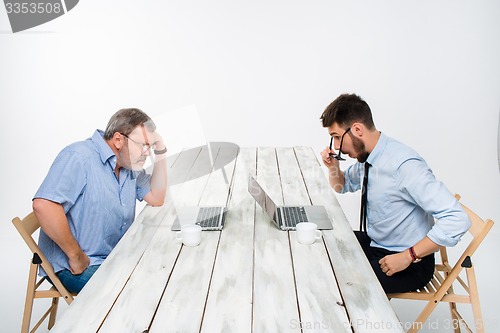 Image of The two colleagues working together  at office on gray background