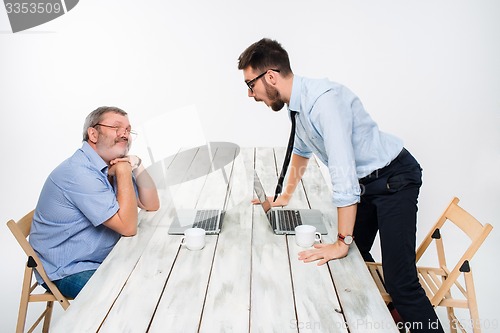Image of The two colleagues working together  at office on gray background