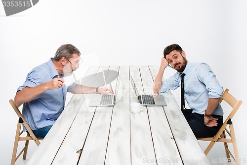 Image of The two colleagues working together  at office on gray background