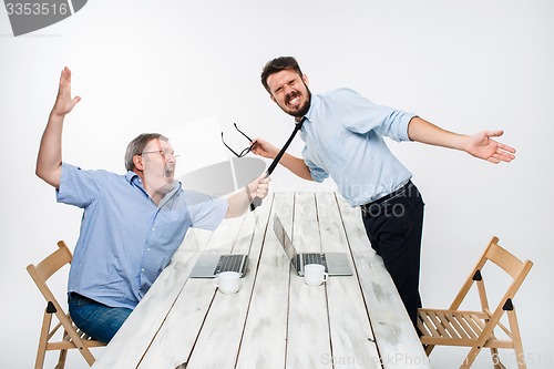 Image of Business conflict. The two men expressing negativity while one man grabbing the necktie of her opponent