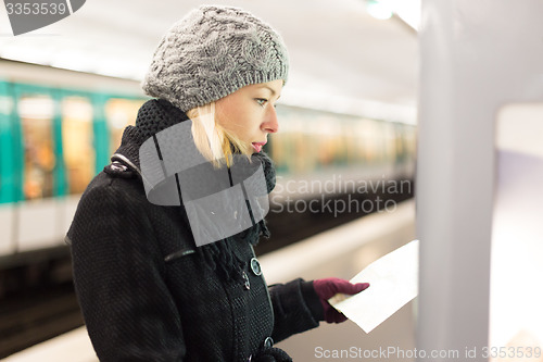 Image of Lady looking on public transport map panel.