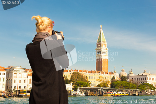 Image of Female tourist taking photo of Venice.