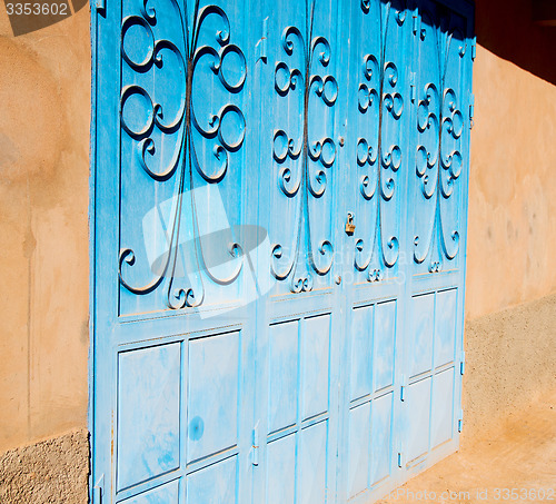 Image of blue morocco old door and historical nail wood