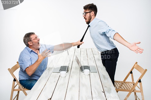 Image of Business conflict. The two men expressing negativity while one man grabbing the necktie of her opponent