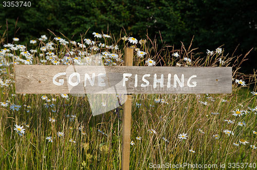 Image of Gone Fishing sign among flowers