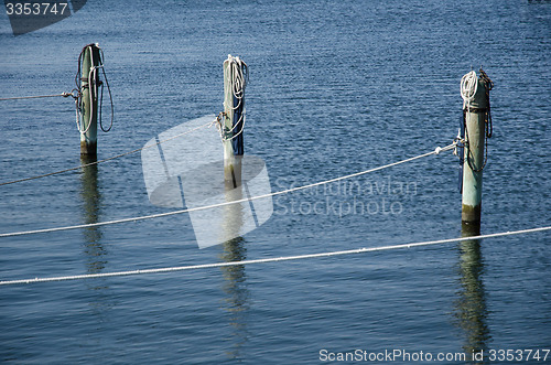 Image of Wooden poles with ropes